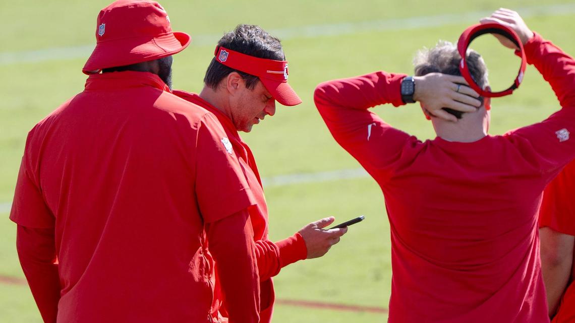 Kansas City Chiefs general manager Brett Veach checks his phone during a Chiefs training camp practice on Tuesday, Aug. 15, 2023, in St. Joseph, Mo.