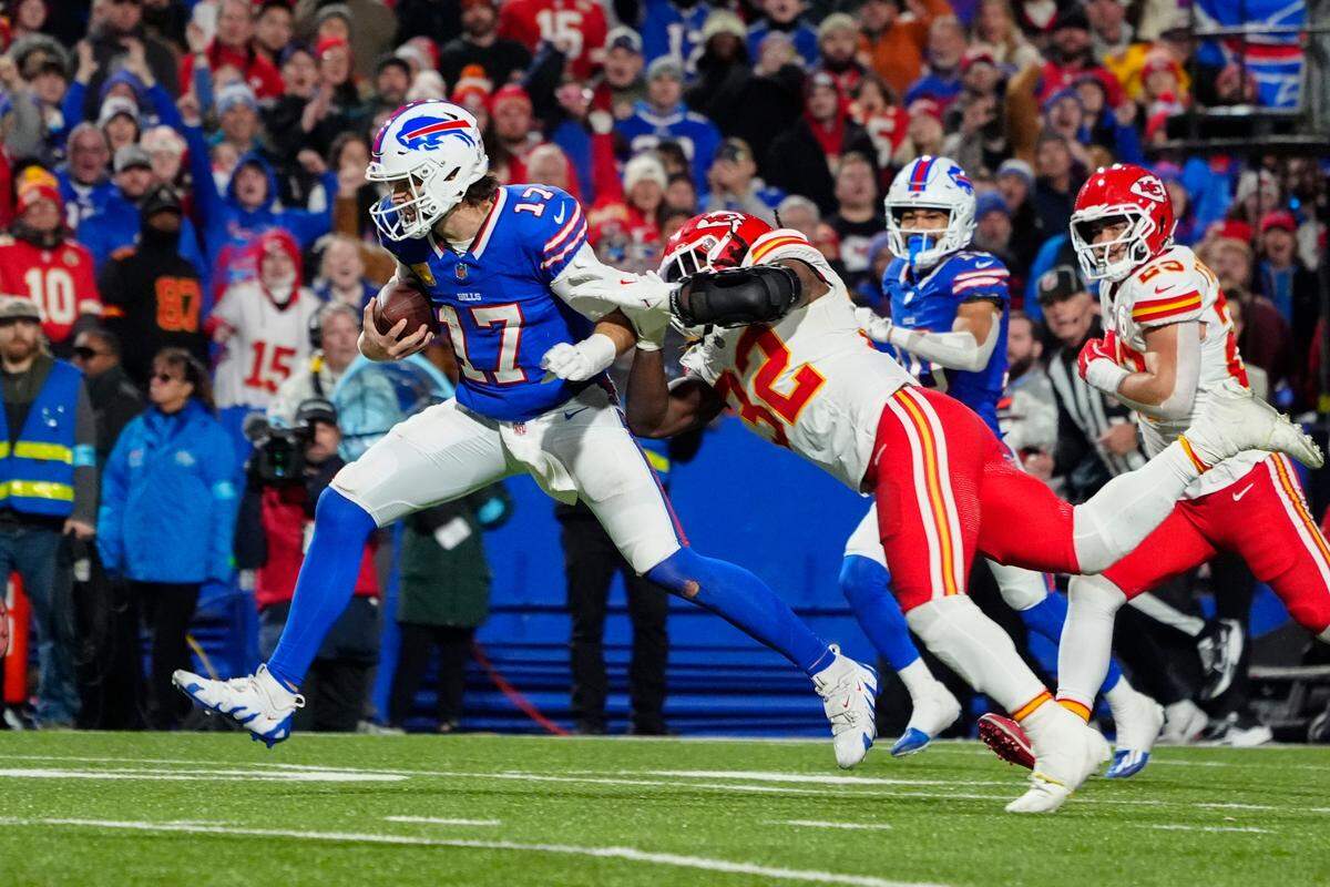 Buffalo Bills quarterback Josh Allen (17) runs with the ball for a touchdown against Kansas City Chiefs linebacker Nick Bolton (32) during the second half on Nov. 17, 2024, at Highmark Stadium in Orchard Park, New York.