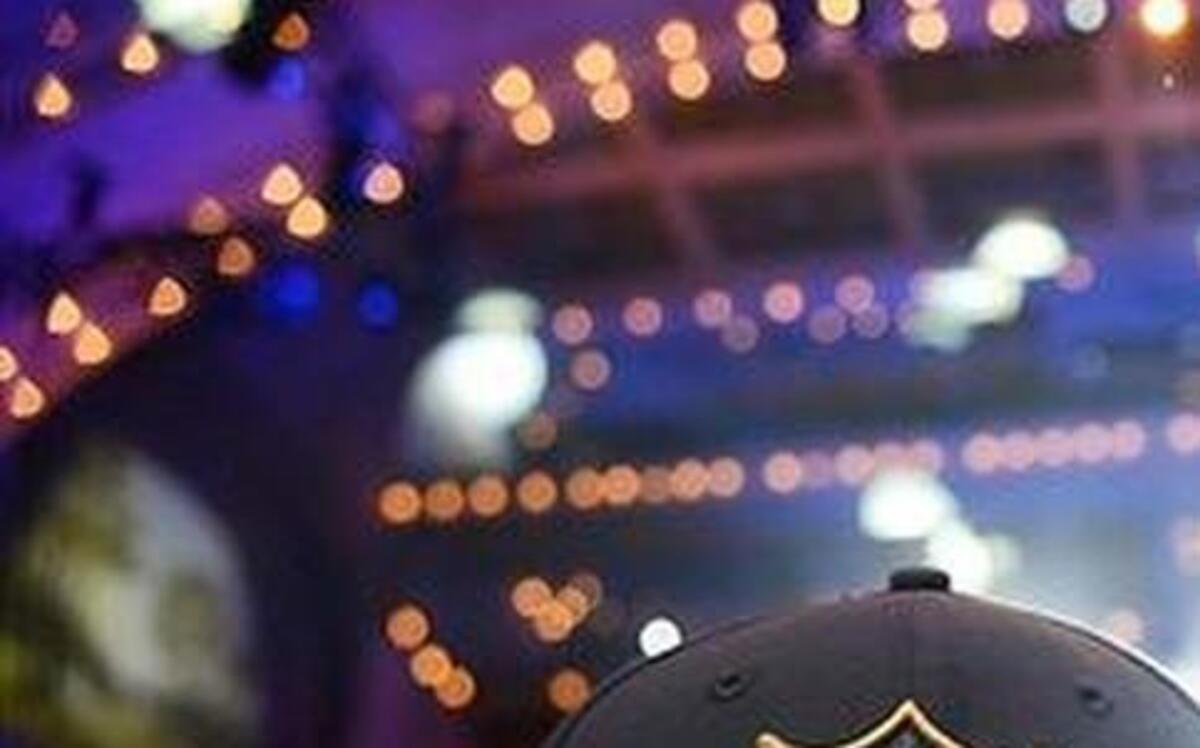 
A fan turns his NFL 2015 Drift cap backward as he watches the crowd during the 2015 NFL Draft in Chicago.
