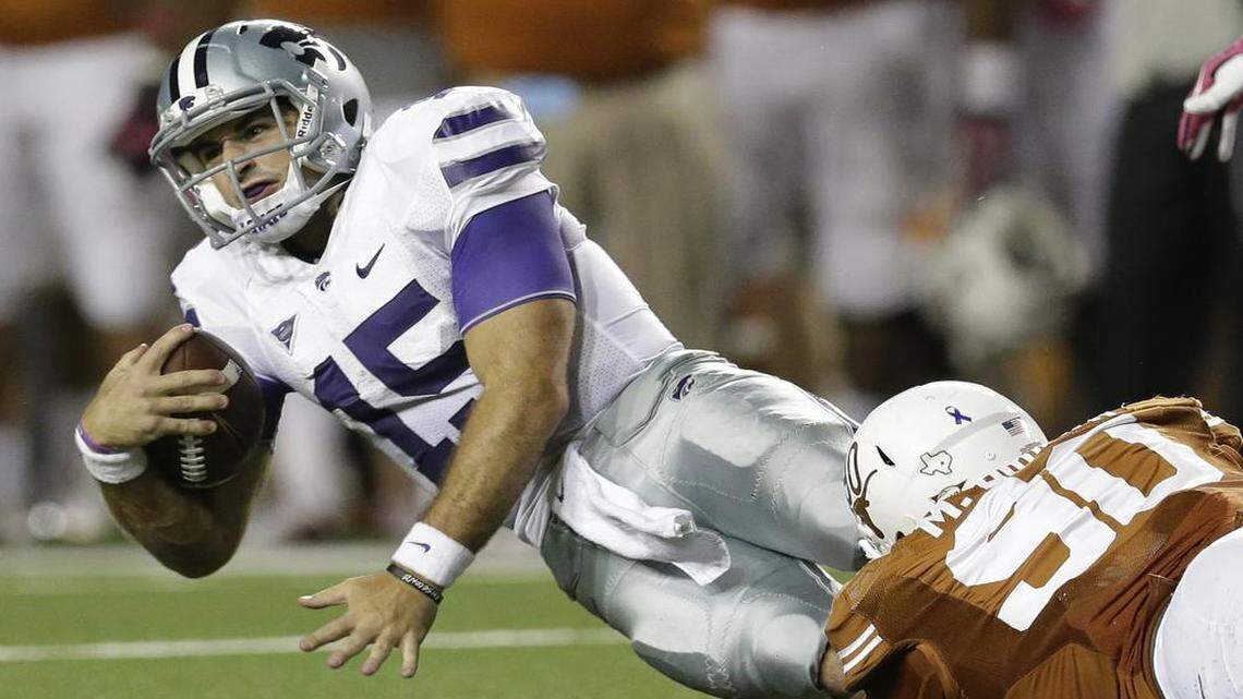 
Kansas State’s Jake Waters was taken down by Texas’ Malcom Brown on Saturday, Sept. 21, 2013, in Austin, Texas.
