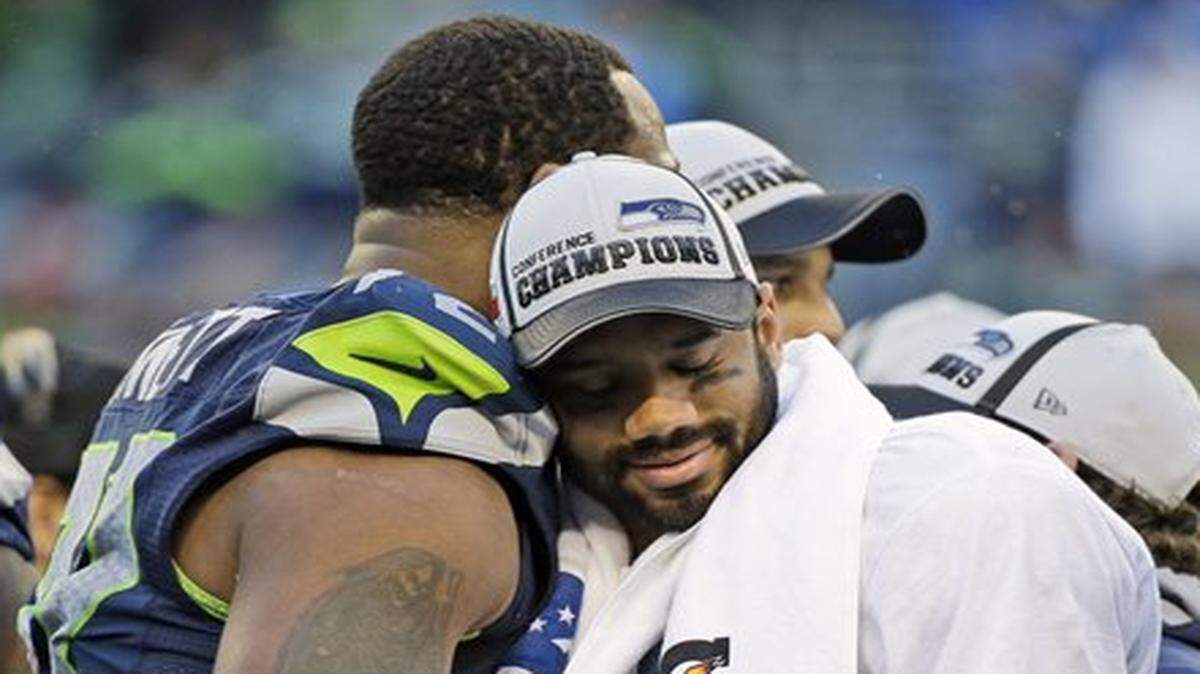 
The Seahawks’ Russell Wilson hugged Michael Bennett after Seattle’s win over the Green Bay Packers in the NFC championship game Sunday.
