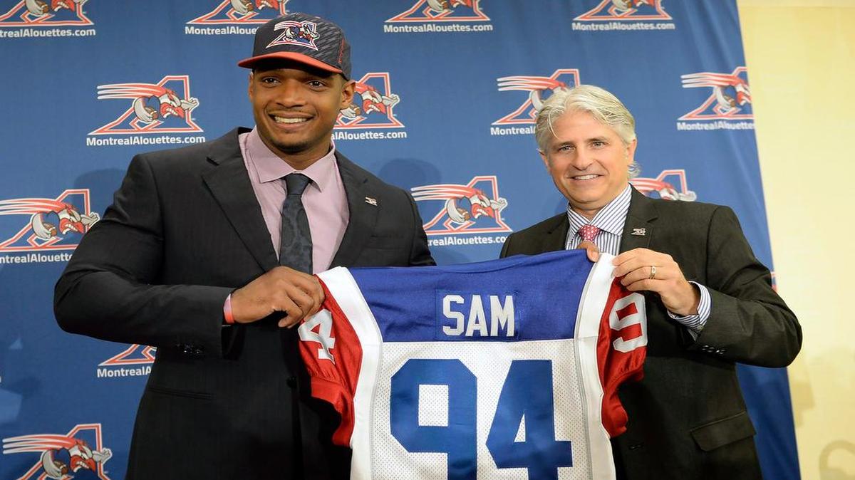 
Montreal Alouettes general manager Jim Popp (right) and newly signed defensive end Michael Sam posed for a photo at a news conference Tuesday in Montreal.
