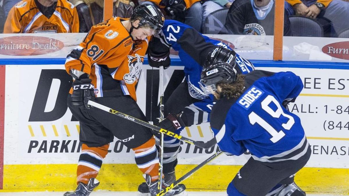 The Mavericks’ Sebastien Sylvestre (left) tangled with Theo Peckham (center) and Joey Sides of the Wichita Thunder in an Oct. 24 game at Silverstein Eye Centers Arena in Independence.