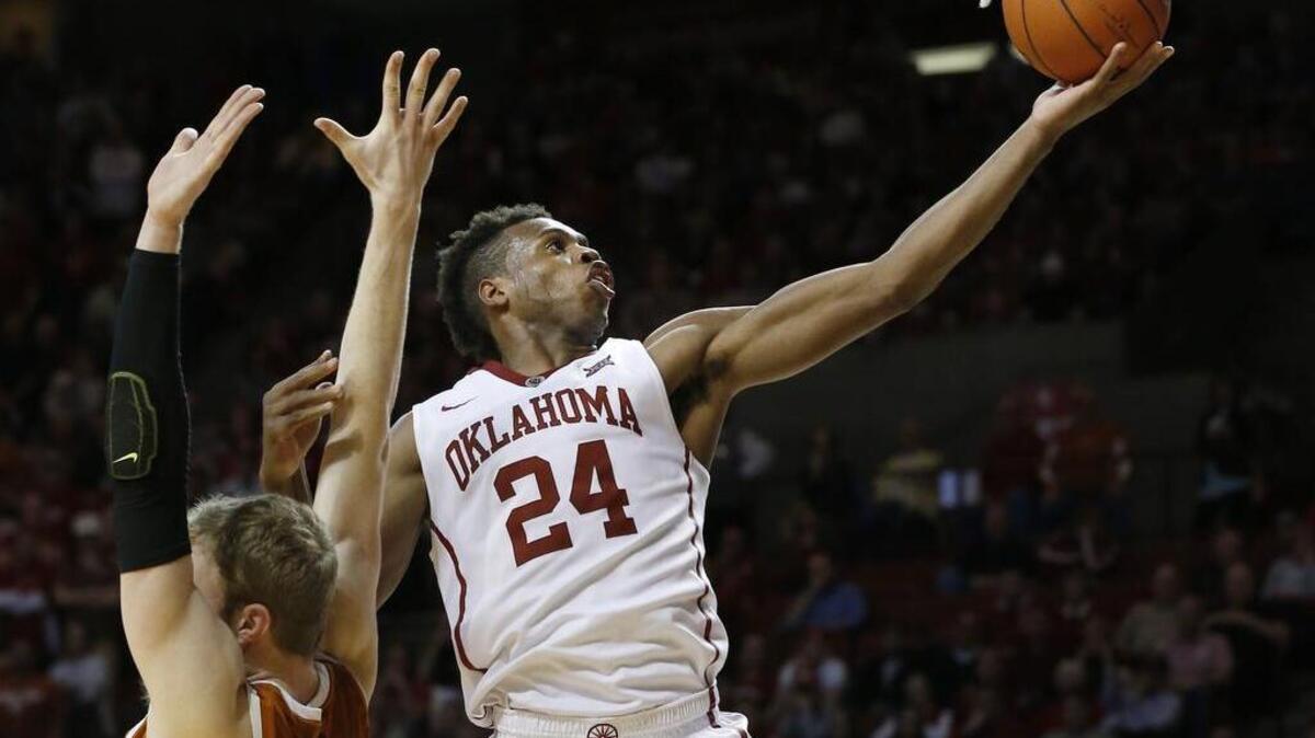 Oklahoma guard Buddy Hield (right) got past Texas forward Connor Lammert for a sehot during the second half Monday. Oklahoma won 63-60.
