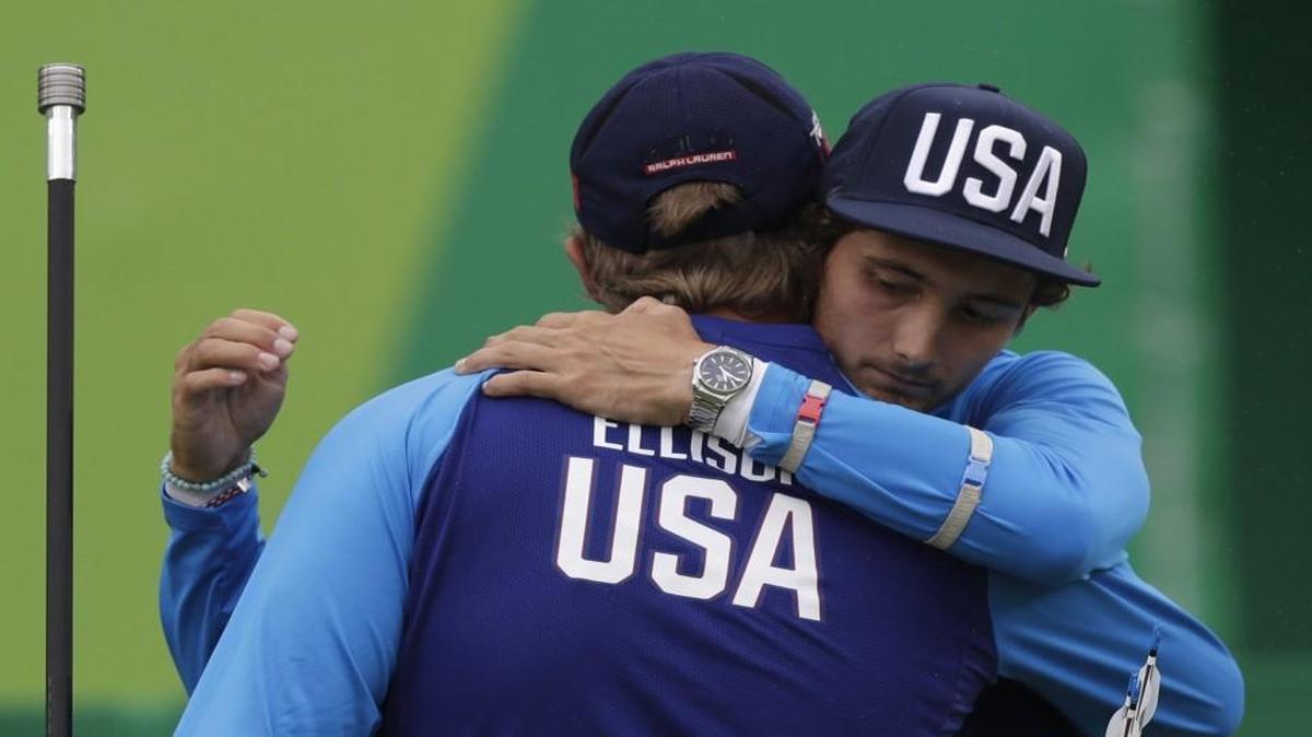 Zach Garrett of the United States (right) hugged his teammate Brady Ellison at the end of their elimination round of the individual archery men's competition at the Sambadrome venue during the 2016 Summer Olympics in Rio de Janeiro, Brazil, Friday, Aug. 12, 2016.
