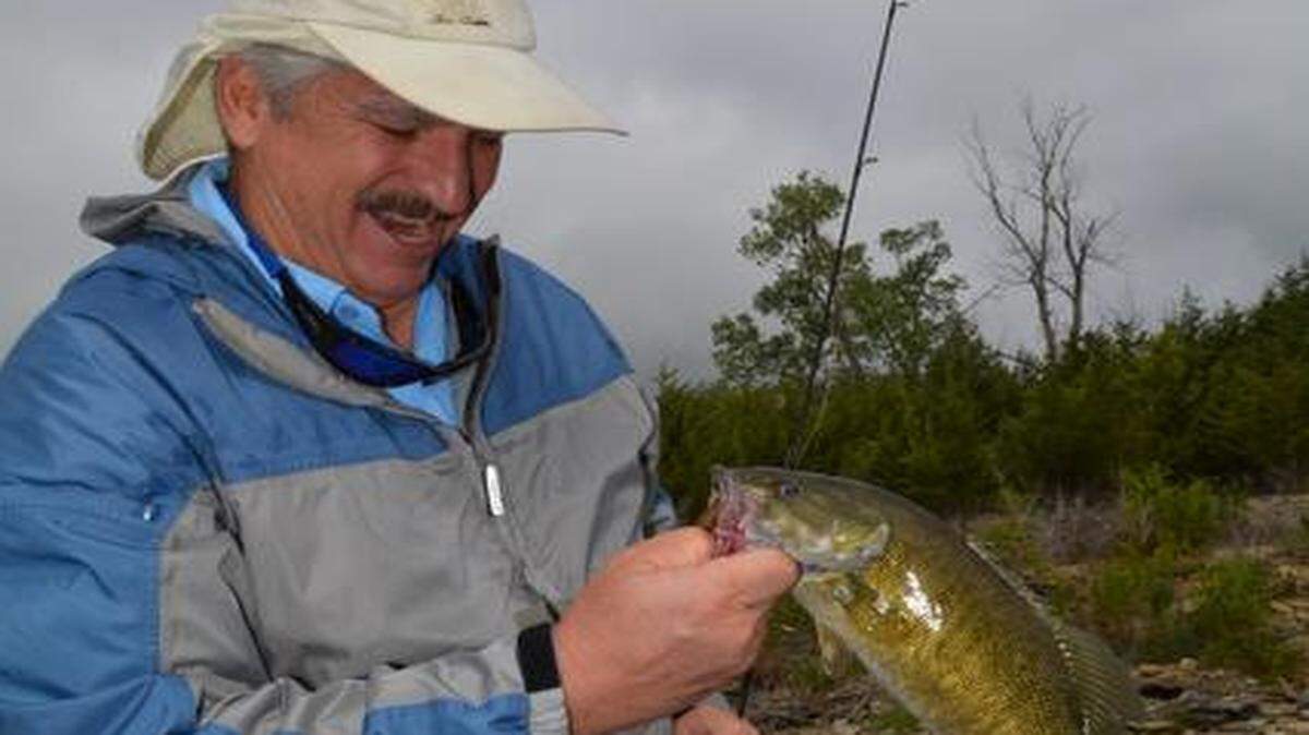 
Rick Dykstra admired one of the smallmouth bass he caught before releasing it.
