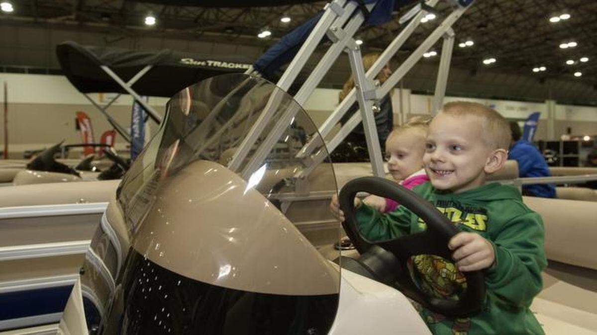 
William Bonham, 4, of Olathe, and his sister Claire, 2, weren’t the only ones imagining themselves captaining boats Saturday in Bartle Hall at the Kansas City Boat & Sportshow. People going to the event also got to see a dock dogs show.
