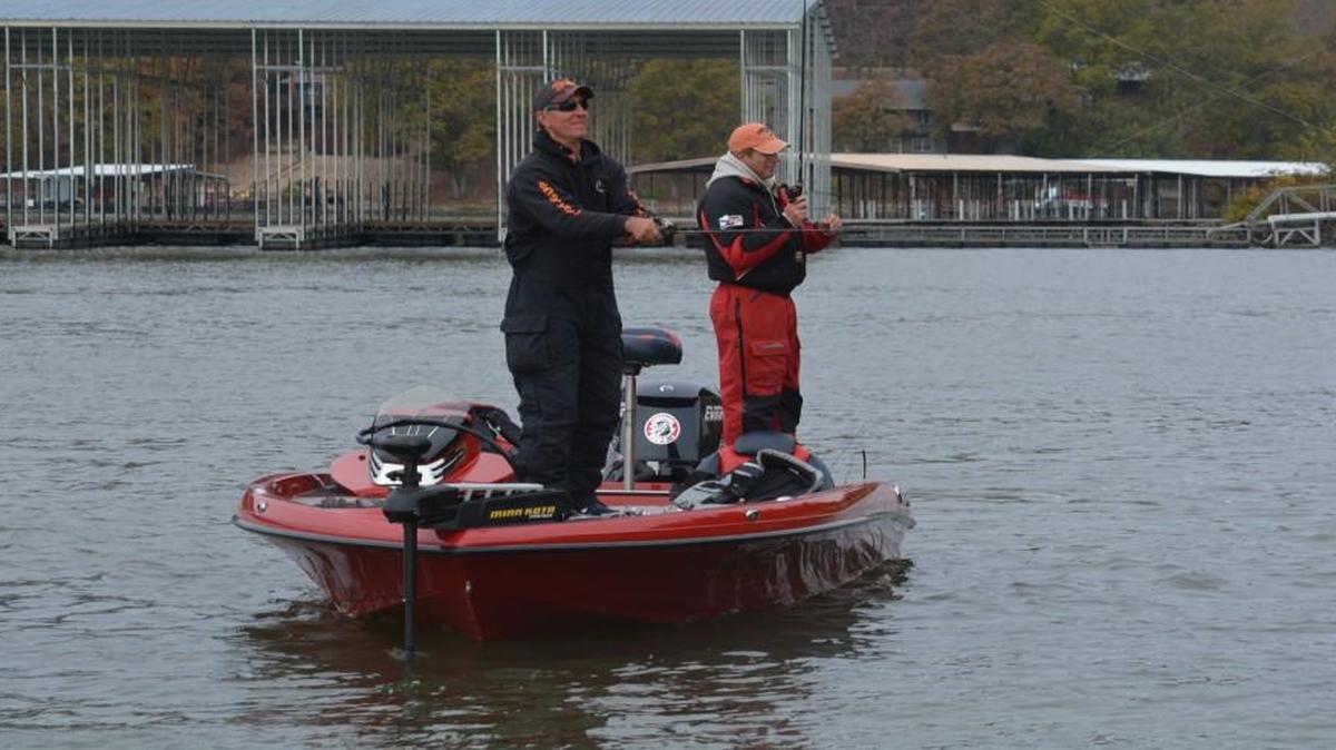 Pro fisherman James Dill (left) and Dana Zander cast for bass along a rocky bank at Lake of the Ozarks.