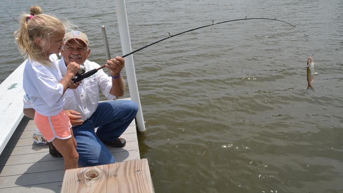 
Phil Taunton was all smiles as he watched Bailey Wiltz, 6, land a small channel catfish at a watershed lake east of Emporia, Kan. Taunton was leading a Fishing’s Future family outing. 
