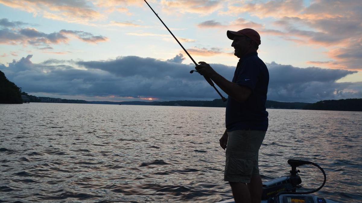 
James Dill fished along a rocky bank at Lake of the Ozarks at dusk, hoping to catch one of the big bass that turn nocturnal in the heat of summer.
