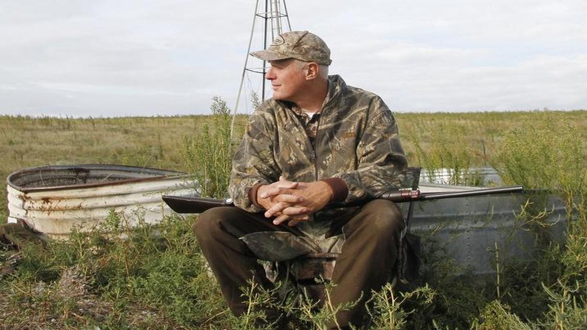 Jim Mellensifer sat by a windmill waiting for doves to come to water. Hundreds eventually came.