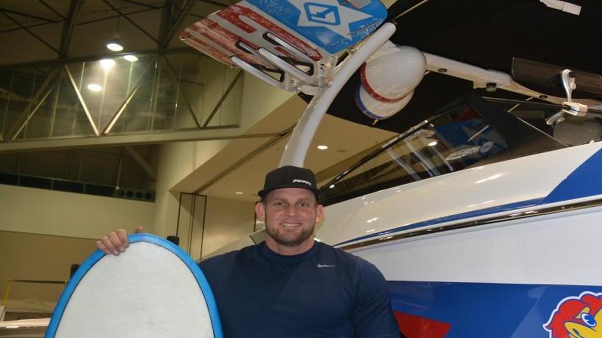 Joe Norton, one of the owners of Performance Marine Watersports, is trying to lure KU basketball fans with the color-design Jayhawk boat he is displaying at the Kansas City Boat and Sportshow.