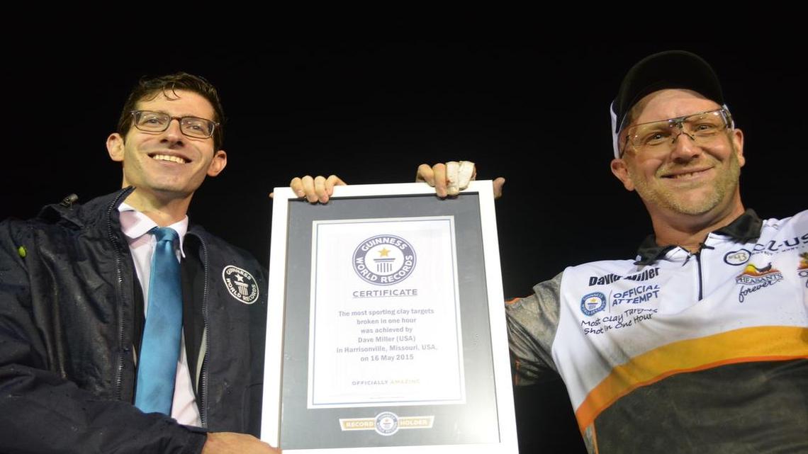 
Pro shooter Dave Miller (right) was smiling Saturday night after accepting recognition from Alex Angert of the Guinness World Records.
