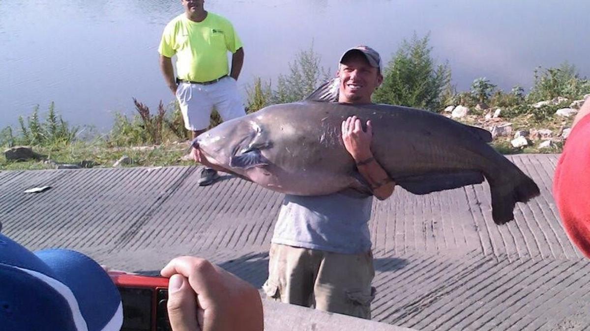 Robert Stanley held up a 102.8-pound blue catfish that he caught on the Kansas River near Kansas City.