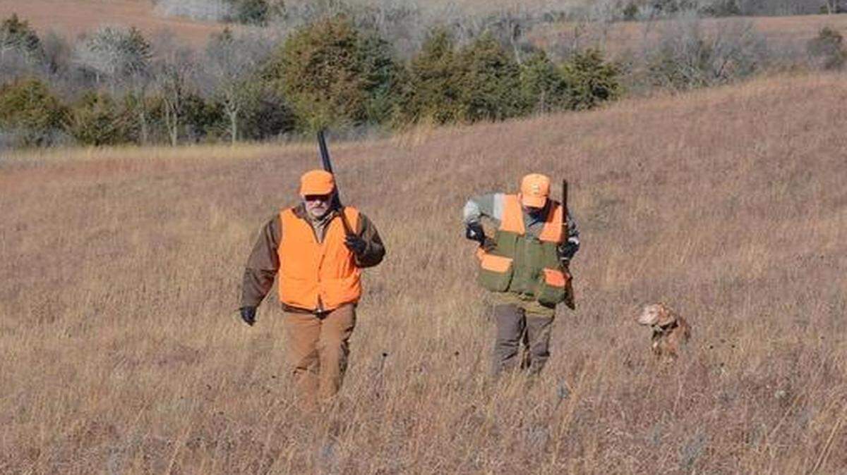 
Jon Blumb (left) and John Hill climbed a hill back to their vehicles after hunting a field at Fort Riley.
