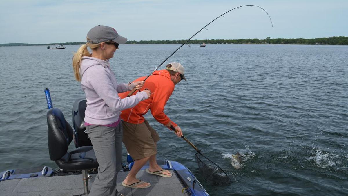 
Becca Doyle, manager of the Kansas City Boat and Sportshow, fought a smallmouth bass to the boat on Mille Lacs Lake as guide Josh Douglas waited with the net.
