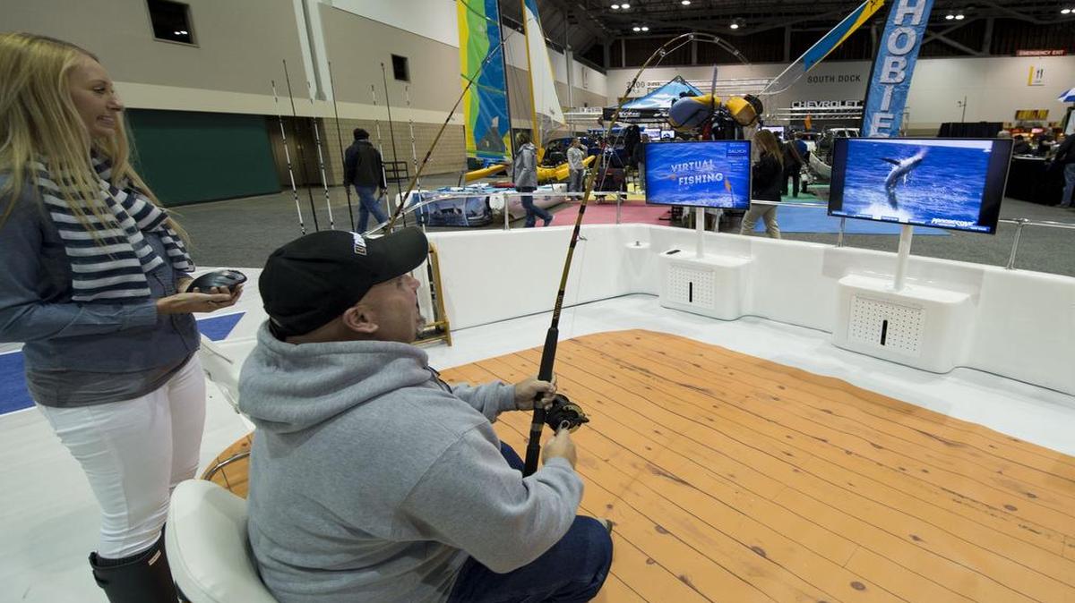 Butch Portell, of Higginsville worked at reeling in a 160-pound Marlin while playing a virtual fishing game at the Kansas City Boat and Sportshow in Bartle Hall on Thursday.