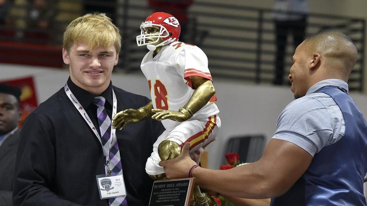 Bobby Bell Award recipient Cale Garrett (left), a senior linebacker from Kearney High School, received his trophy last week at the Thomas A. Simone Awards program.