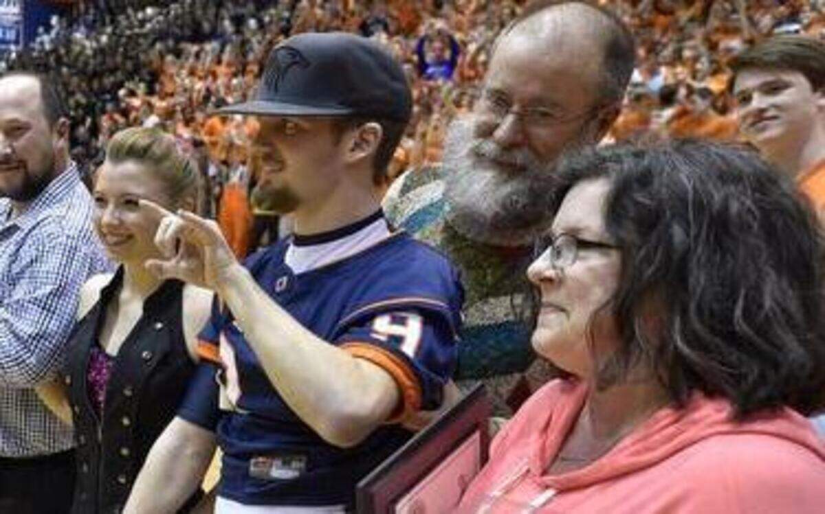 James McGinnis (right) was honored during Senior Night festivities Friday at Olathe East High School. He was joined by his parents, Patrick and Susan McGinnis (far right), and his girlfriend, Caitlin Gosik, who had a firm hold on James’ hand. Go to KansasCity.com for a video.