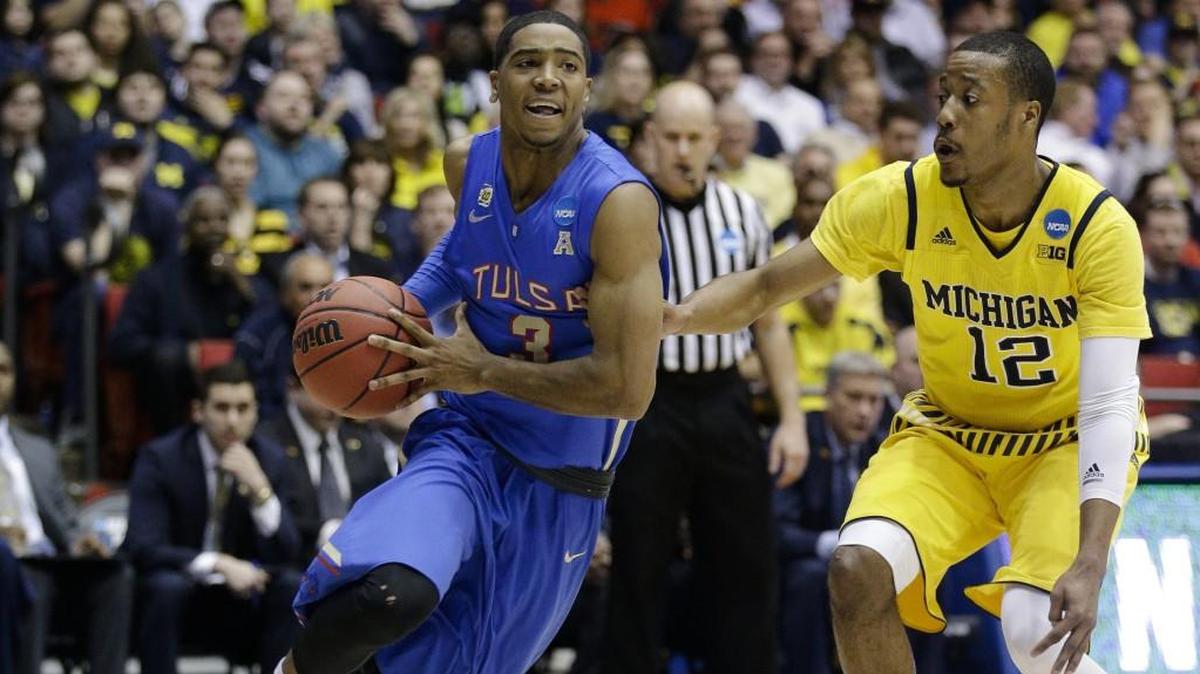 Shaquille Harrison (left) — shown here as a college player at Tulsa driving against Michigan’s Muhammad-Ali Abdur-Rahkman (12) during an NCAA Tournament game in Dayton, Ohio in this March 2016 file photo — led Lee’s Summit West to the 2012 Class 5 state tournament his senior year before moving on to Tulsa and the NBA G League. Harrison was called up Feb. 21 by the Phoenix Suns from their developmental team and signed to a 10-day contract.