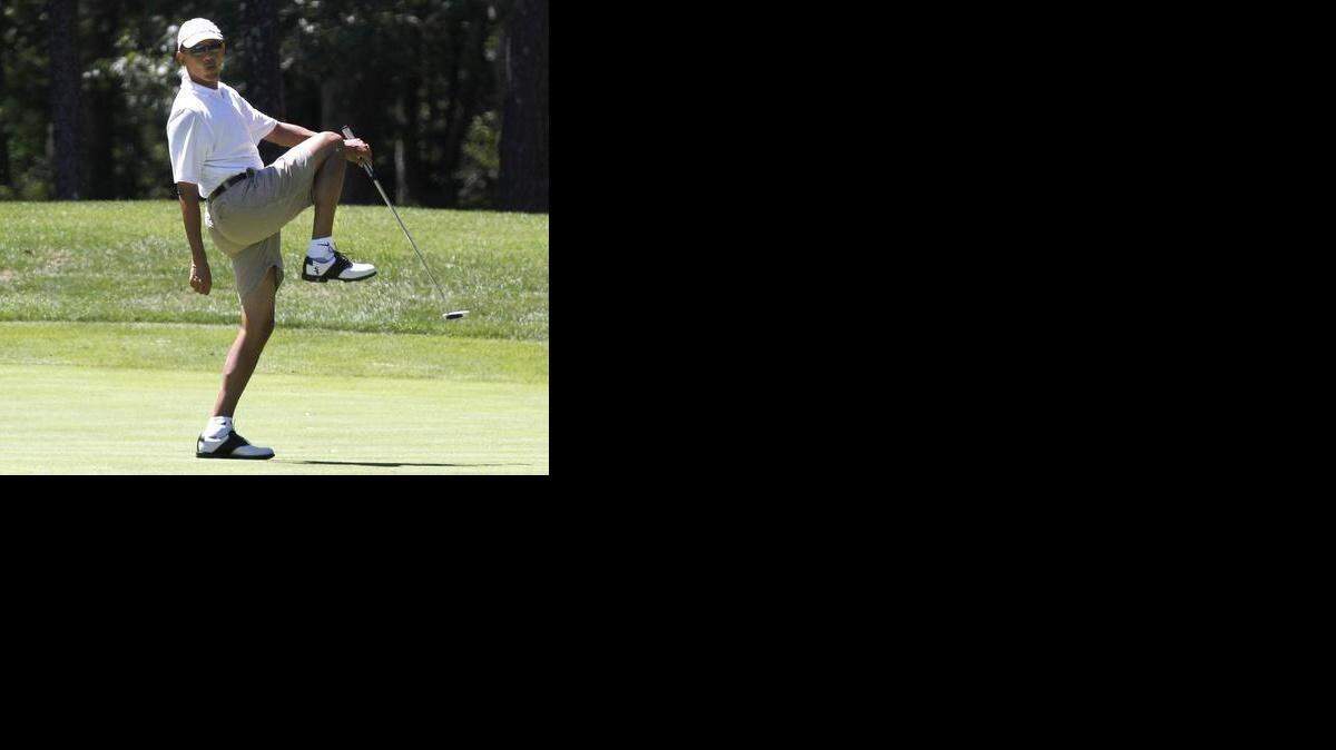
In this Aug. 11, 2013, file photo President Barack Obama reacted after missing a shot while golfing on the first hole at Farm Neck Golf Club in Oak Bluffs, Mass., on the island of Martha’s Vineyard.
