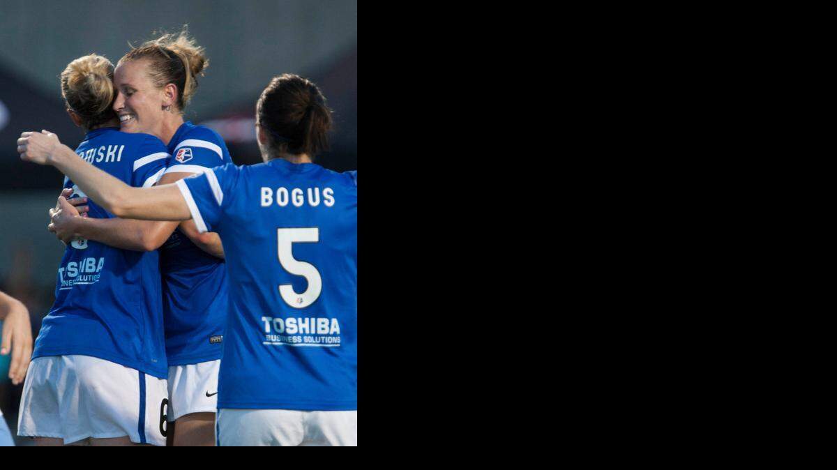 
FCKC’s Jen Buczkowski (center) celebrated Saturday’s lone goal with teammates Leigh Ann Robinson (left) and Liz Bogus.
