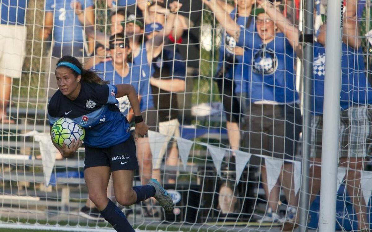 Forward Shea Groom collects the ball from the net after scoring during FC Kansas City’s 3-2 loss to Washington on July 16.