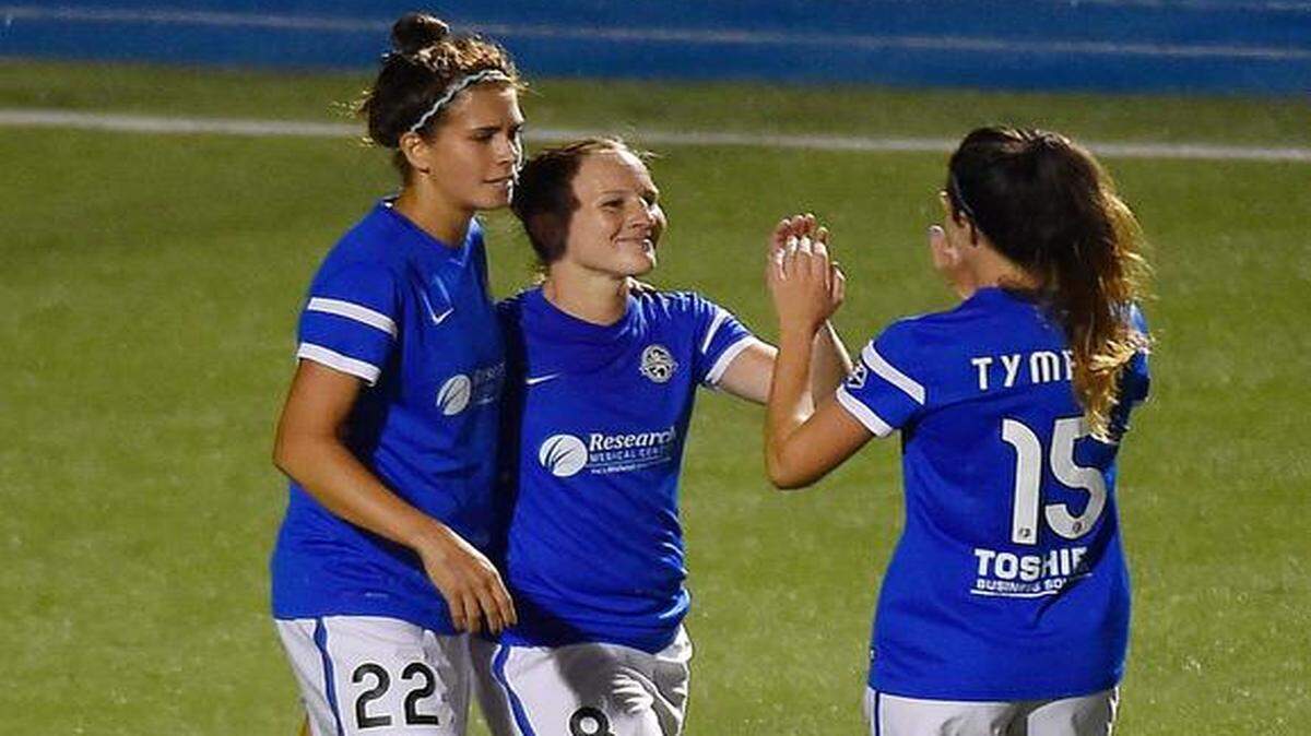 FC Kansas City's Amy Rodriguez (center) celebrated her eighth-minute goal in the victory over Boston.<252><137> with teammates Sarah Hagen (22) and Erika Tymrak (15). FCKC hosted Boston Breakers at UMKC's Durwood Stadium and led 2-1 at the half Wednesday, Aug. 6, 2014.<252><137>