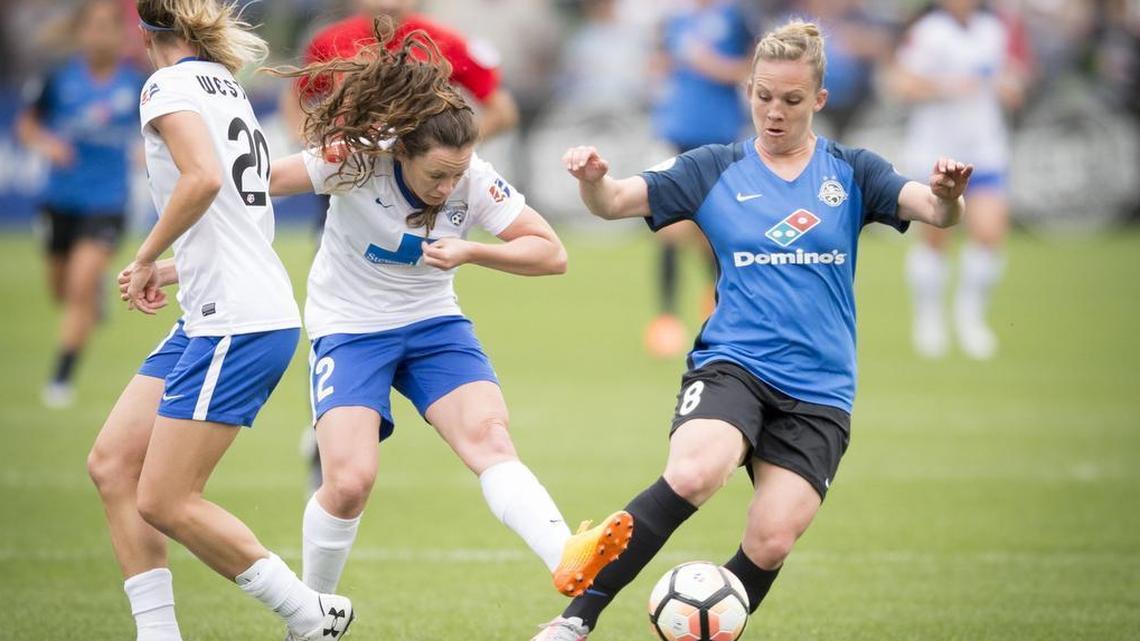 FC Kansas City’s Amy Rodriguez (right) battled the Boston Breakers’ Christen Westphal (left) and Allysha Chapman for the ball in the first half of FCKC’s 2-0 win Sunday at Swope Soccer Village. Rodriguez scored a goal before she left the game because of a knee injury.