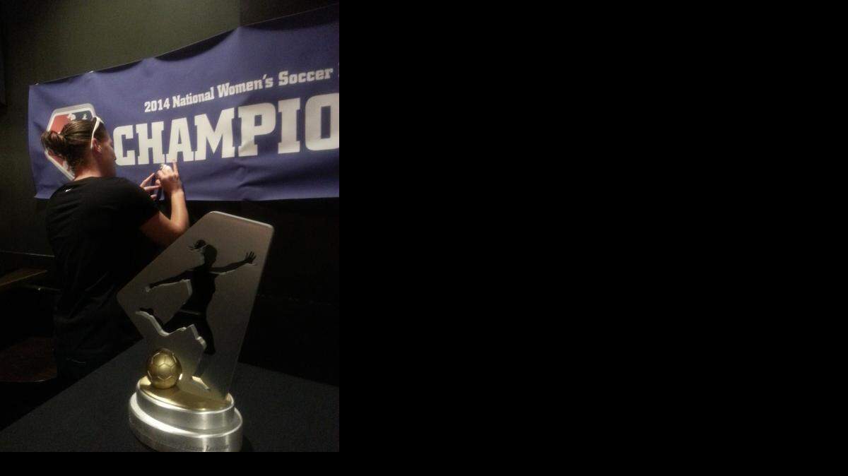 
FCKC’s Nicole Barnhart signed an autograph for a fan at Granfalloon on Thursday in front of the NWSL championship trophy.
