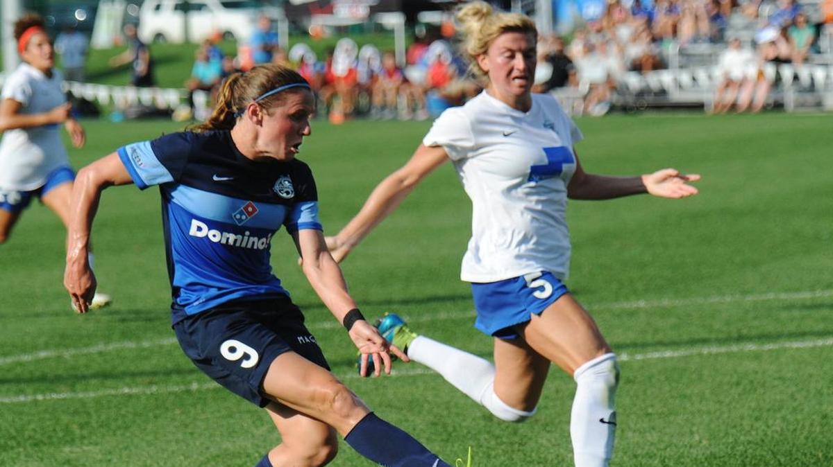 FC Kansas City midfielder Heather O'Reilly passes the ball as Boston's Kassey Kallman plays defense last season at Swope Soccer Village. FC KC lost 2-0.