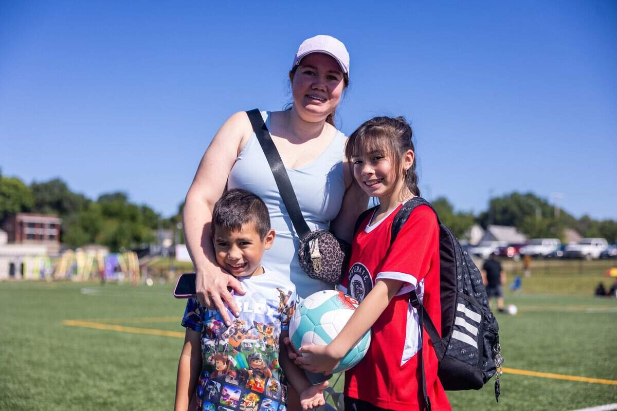 Kendra Guerrero and her children, Raúl and Ximena, during the opening ceremony of the Kansas City Current’s No-Cost, No-Barrier Soccer League at 901 Van Brunt Blvd on Friday, July 10, 2026. The league, presented by CVS Health, aims to increase youth soccer participation, particularly among girls, while providing education for coaches and referees.