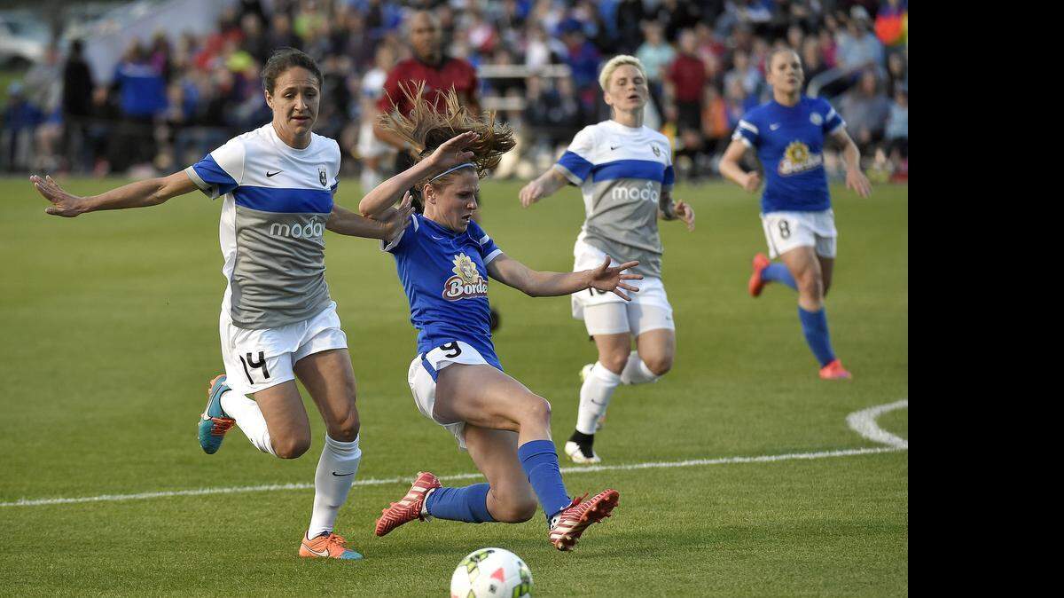 
Seattle Reign FC defender Stephanie Cox (14) and FC Kansas City midfielder Heather O'Reilly (9) scramble for control of the ball in the first half during Thursday's soccer game on April 23, 2015 at Swope Soccer Village in Kansas City, Mo.
