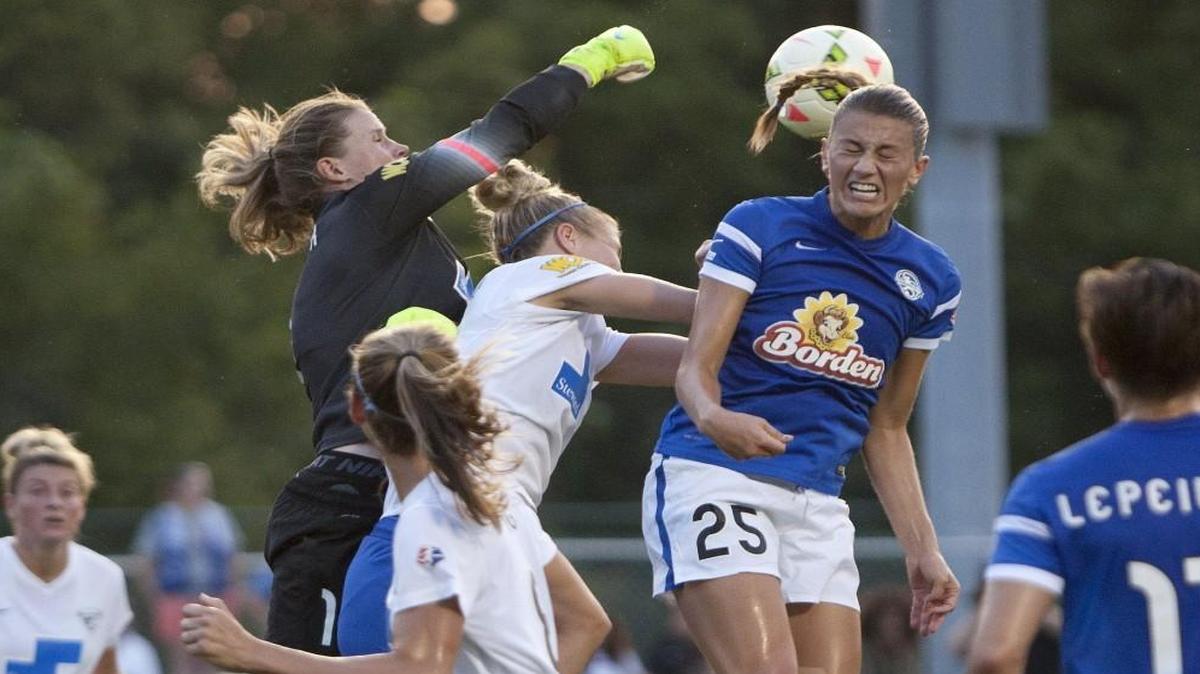 Boston Breakers Goalkeeper Alyssa Naeher punched the ball over the attempted header of FC Kansas City midfielder Mandy Laddish during a game this year.