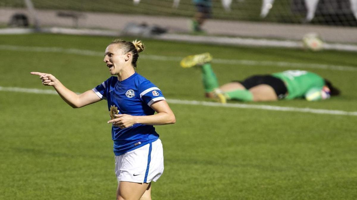 
FC Kansas City player Amy Rodriguez reacted after kicking the ball past Portland FC goalie Michelle Betos during the second half Wednesday at Swope Soccer Village. FC Kansas City won 3-0.
