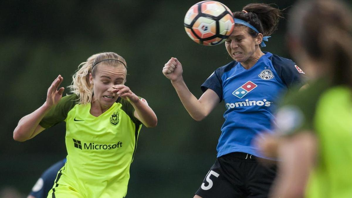 FC Kansas City Midfielder Erika Tymrak (right) headed the ball away from Seattle Reign forward Beverly Yanez during the match between the two teams last Saturday (June 17) at Swope Soccer Village.