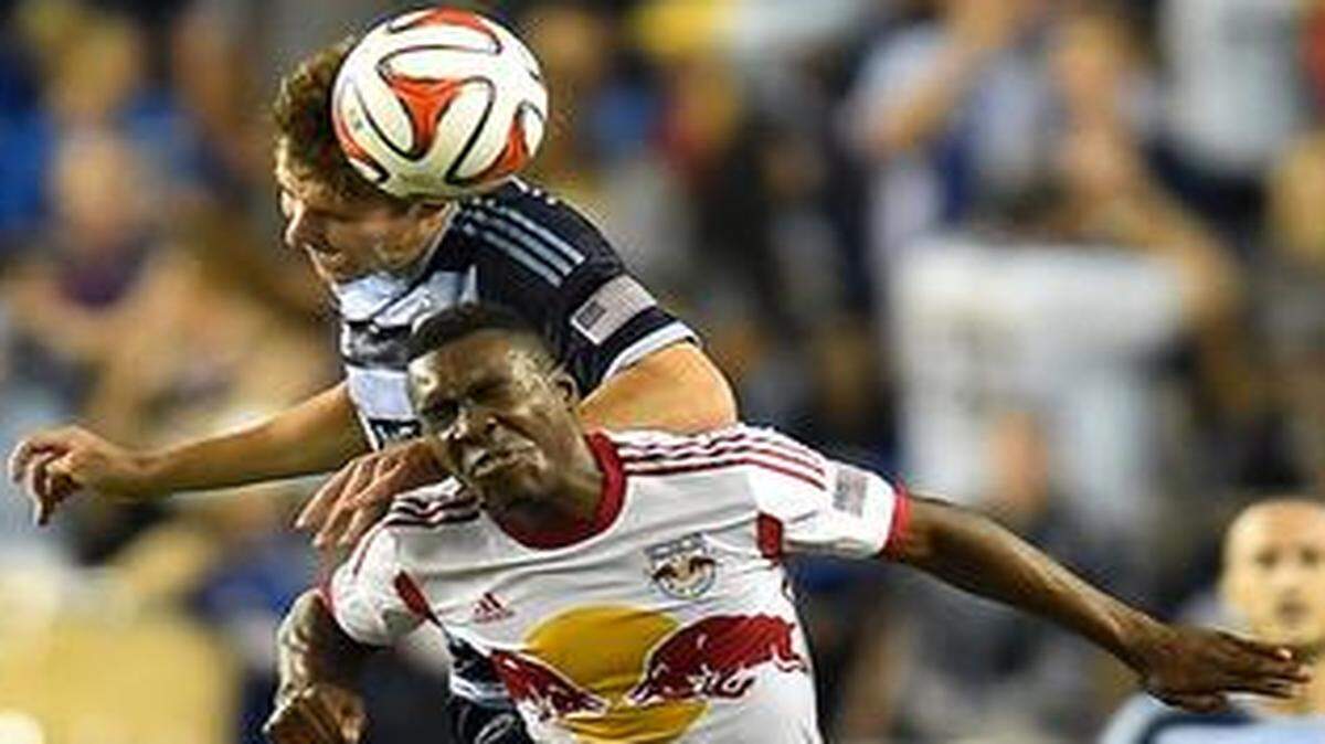 
Sporting Kansas City’s Matt Besler and the New York Red Bulls’ Lloyd Sam (10) battled for the ball in the first half Sunday night at Sporting Park. The Red Bulls won the match 2-0.
