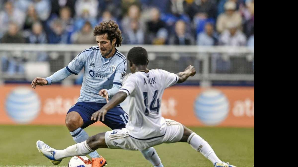 
Sporting Kansas City midfielder Benny Feilhaber (10) keeps control of the ball away from Philadelphia Union midfielder Eric Ayuk Mbu (14) on Sunday, April 5, 2015, during the first half of the MLS soccer match at Sporting Park in Kansas City, Kan. Sporting KC won 3-2.
