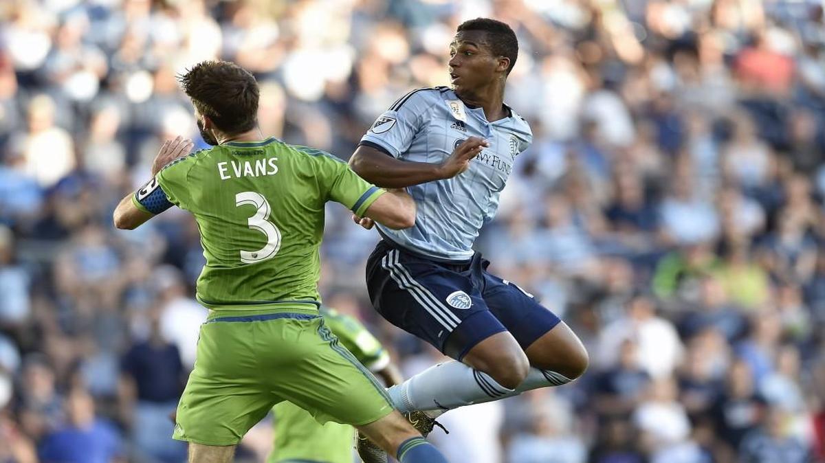 Seattle's Brad Evans (3) and Sporting Kansas City's Erik Palmer-Brown (right) look back to see if Palmer-Brown's header went into the goal as Sporting KC hosted the Sounders Sept. 27 at Sporting Park