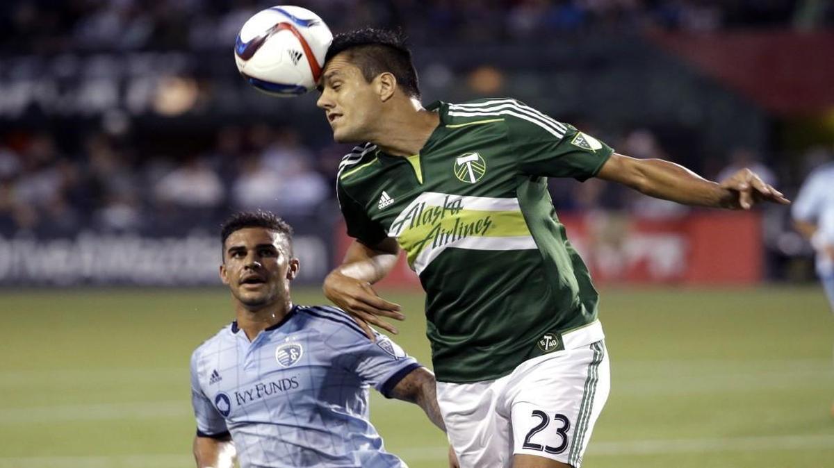 
Portland Timbers defender Norberto Paparatto (right) headed the ball away from Sporting Kansas City forward Dom Dwyer in the first half on Wednesday night in Portland, Ore. The teams played to a scoreless draw.
