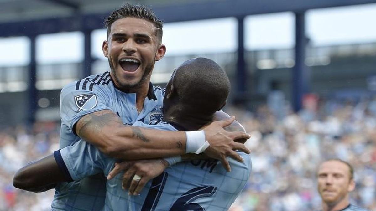 Sporting Kansas City’s Dom Dwyer jumped into teammate Lawrence Olum’s arms to celebrate Olum’s opening goal Sunday against FC Dallas. Game officials missed a clear goal by Dallas earlier in that game.