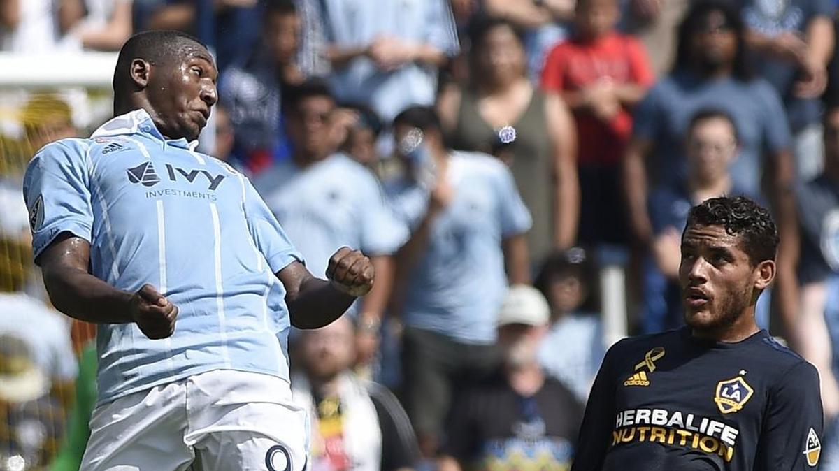 Sporting KC’s Jimmy Medranda (left) heads the ball away from LA Galaxy’s Jonathan dos Santos during the first half of a 2017 game at Children’s Mercy Park. Sporting KC won 2-1.