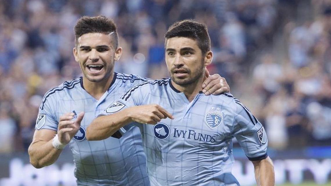 
Sporting KC forward Dom Dwyer (left) celebrated with teammate Sporting KC midfielder Paulo Nagamura after scoring his first goal in the second half against Vancouver. Sporting won 4-3.
