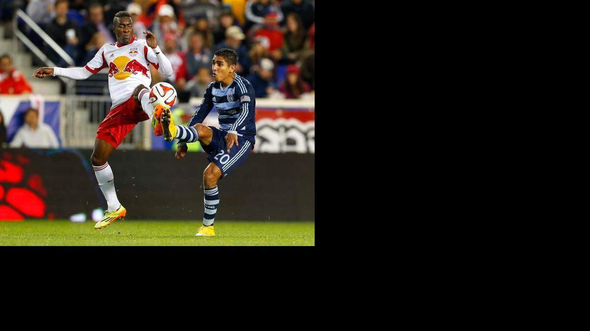 
New York Red Bulls midfielder Lloyd Sam (left) battled Sporting Kansas City midfielder Jorge Claros for the ball in the first half on Oct. 30, 2014, at Red Bull Arena in Harrison, N.J.
