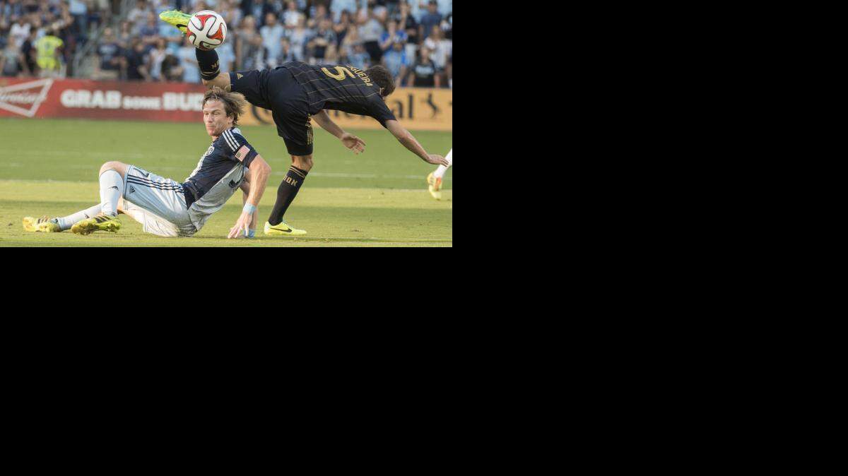 
Sporting KC forward Jacob Peterson slid as Philadelphia Union midfielder Vincent Nogueira dived for the ball in a game in August.
