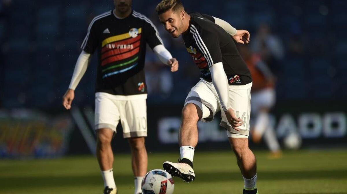 Sporting Kansas City Benny Feilhaber (left) and Dom Dwyer wear warm up jerseys similar to the uniforms the Kansas City Wiz wore in 1996, their first MLS season.