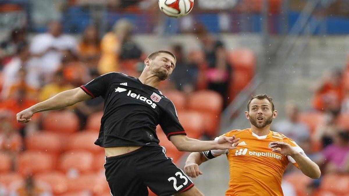 Midfielder Brad Davis (right) went up for a header against D.C. United’s Perry Kitchen during a game in 2014.