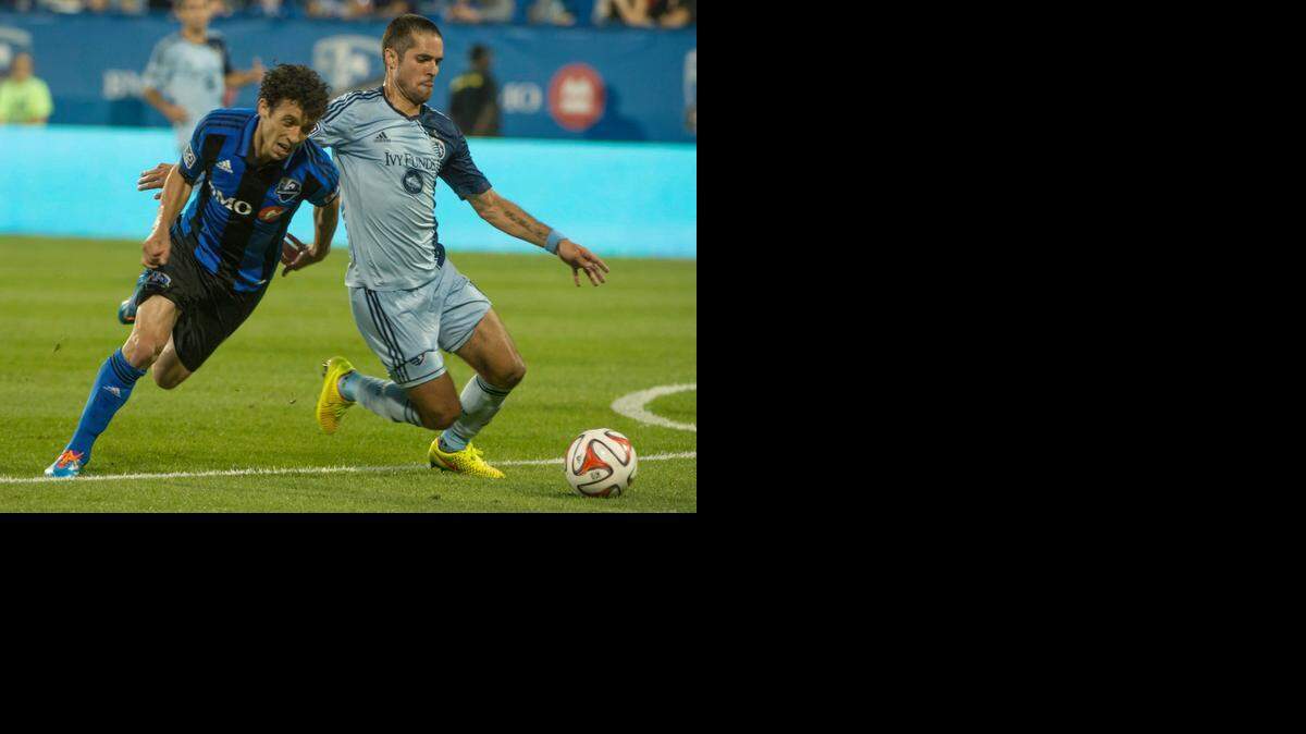 
The Montreal Impact’s Felipe Martins and Sporting Kansas City’s Benny Feilhaber battled for the ball in the second half Saturday night in Montreal. Sporting won the match 2-1.
