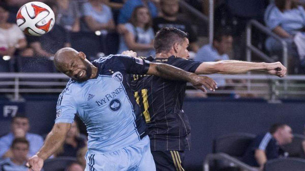 Sporting KC defender Kevin Ellis (left) flipped the ball away from Philadelphia Union forward Sebastien Le Toux in a game last summer.
