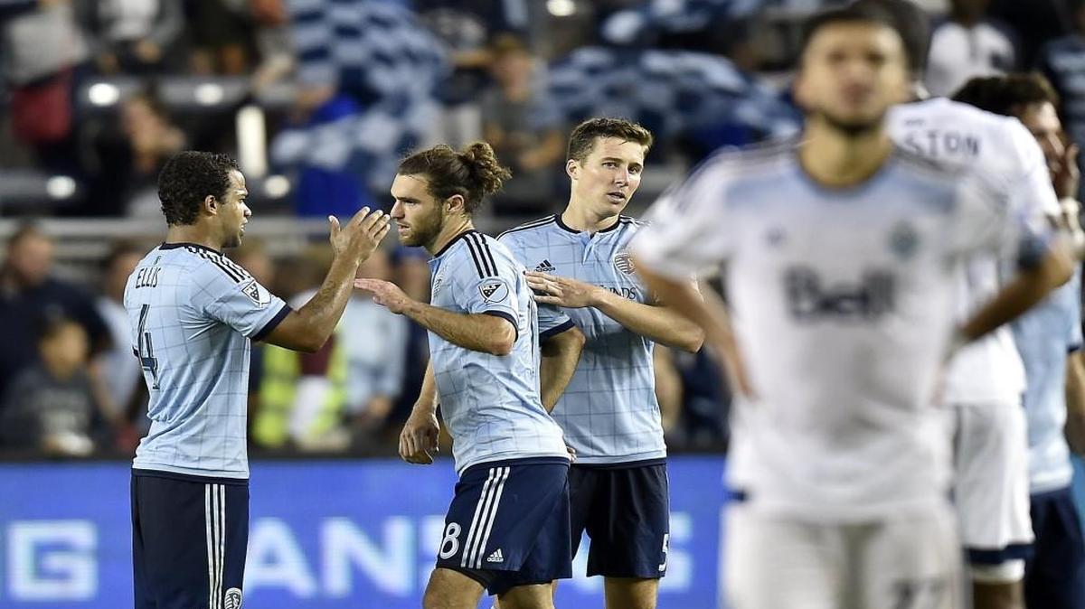 Sporting Kansas City players Kevin Ellis (4), Graham Zusi (8) and Matt Besler (5) celebrated after beating the Vancouver Whitecaps FC on Saturday night at Children’s Mercy Park, but on Wednesday, Major League Soccer gave Ellis a one-match suspension for inadvertently elbowing Vancouver midfielder Giles Barnes in the face earlier in the match.